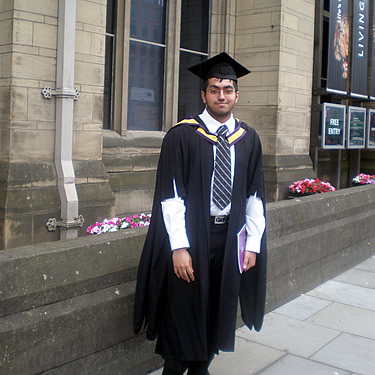 Adil after his graduation ceremony, standing outside Manchester Museum.