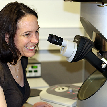 Sarah looking particularly happy while sitting at her microscope!