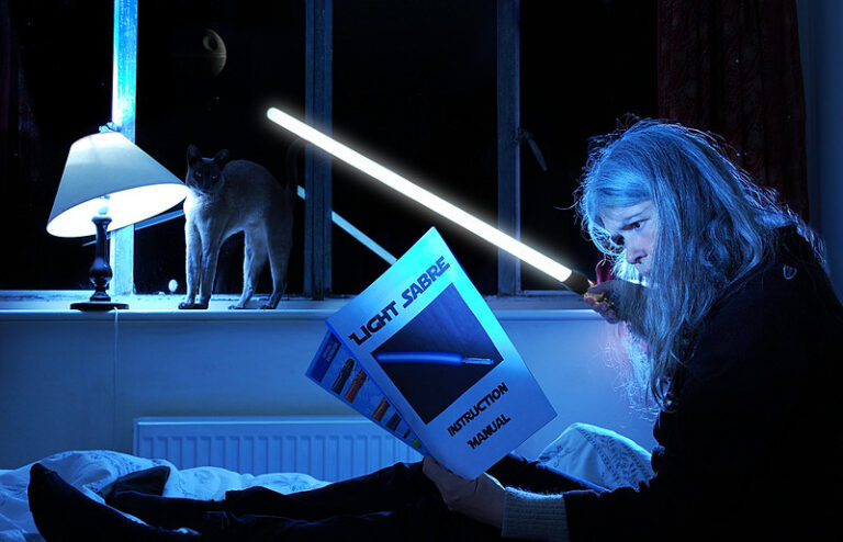 Woman in bed with lightsaber instructions