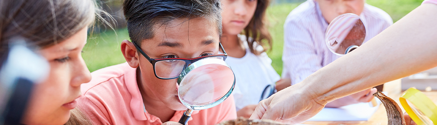 Children using a magnifying glass