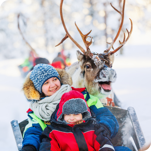 Children wrapped up warm with a reindeer sticking it's tongue out